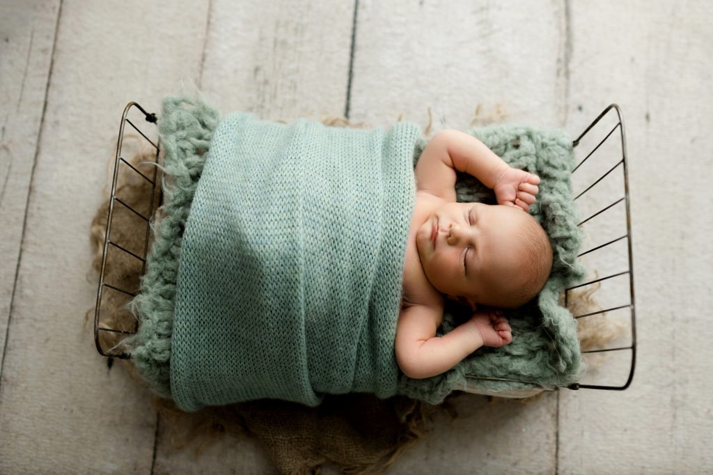 springville al baby on a bed sleeping with green blanket lane weichman newborn session
